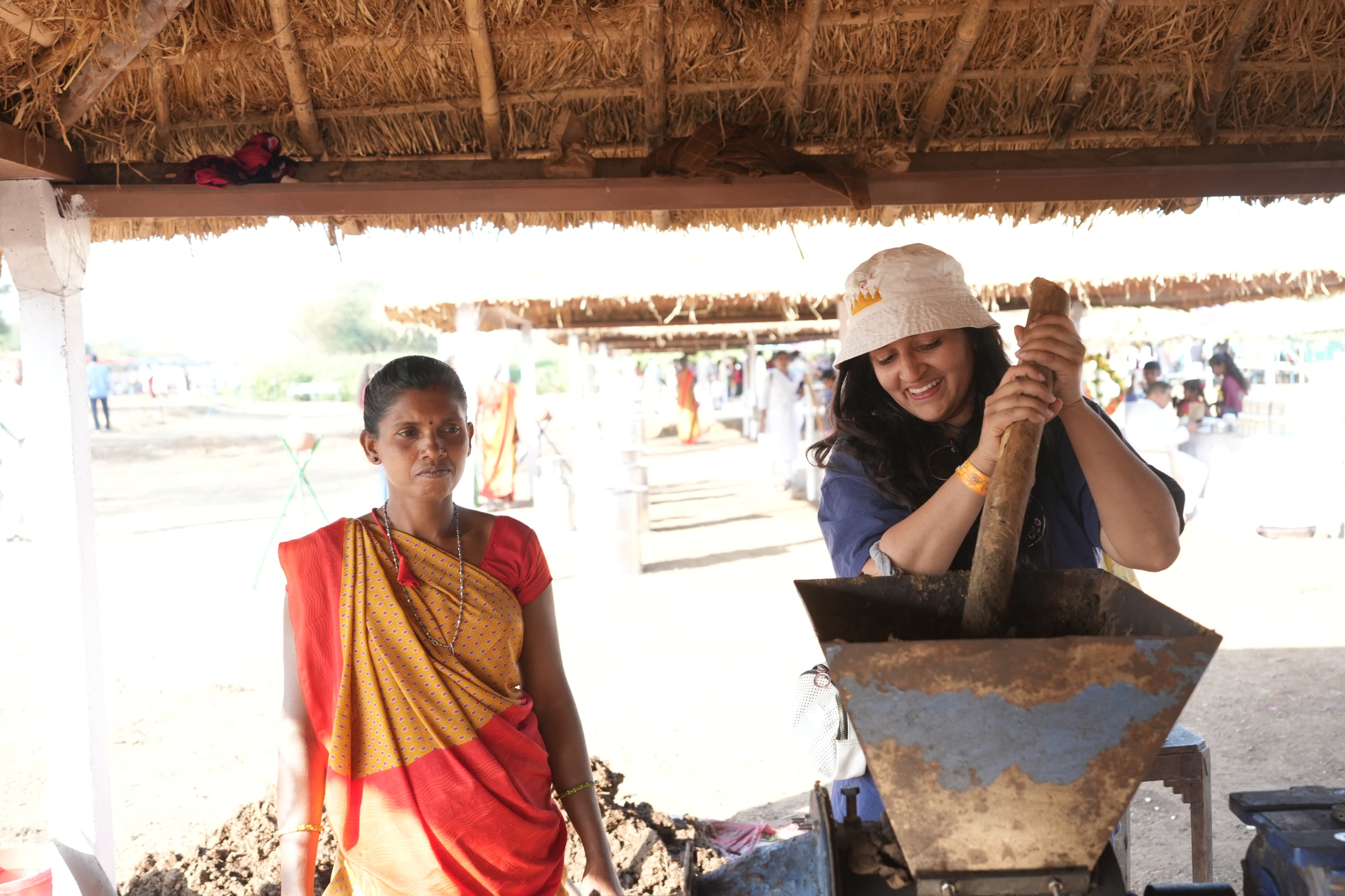 A festival participant learns alongside a community member during a rural immersion