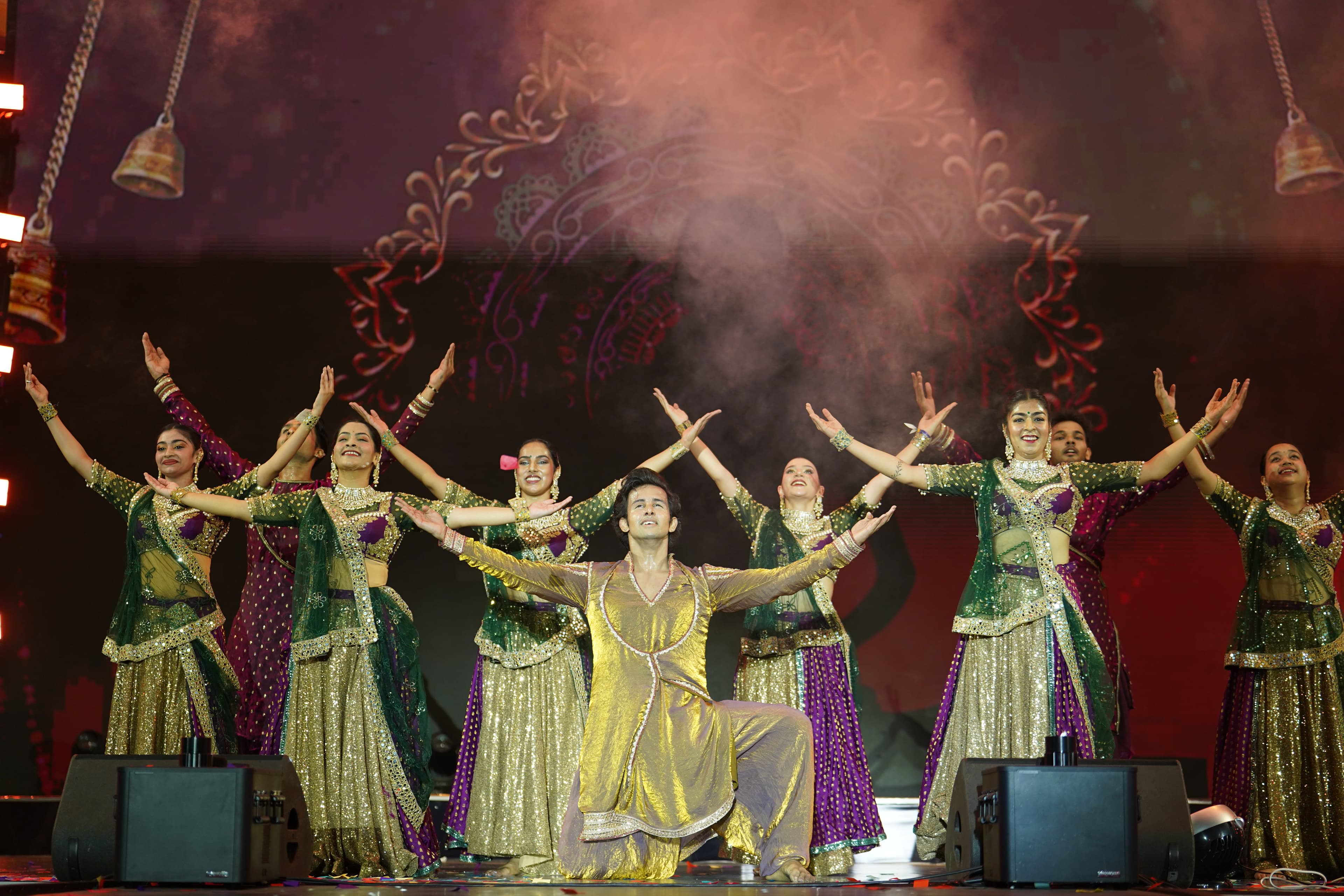 Dancers perform together in colourful costumes on the GYF stage