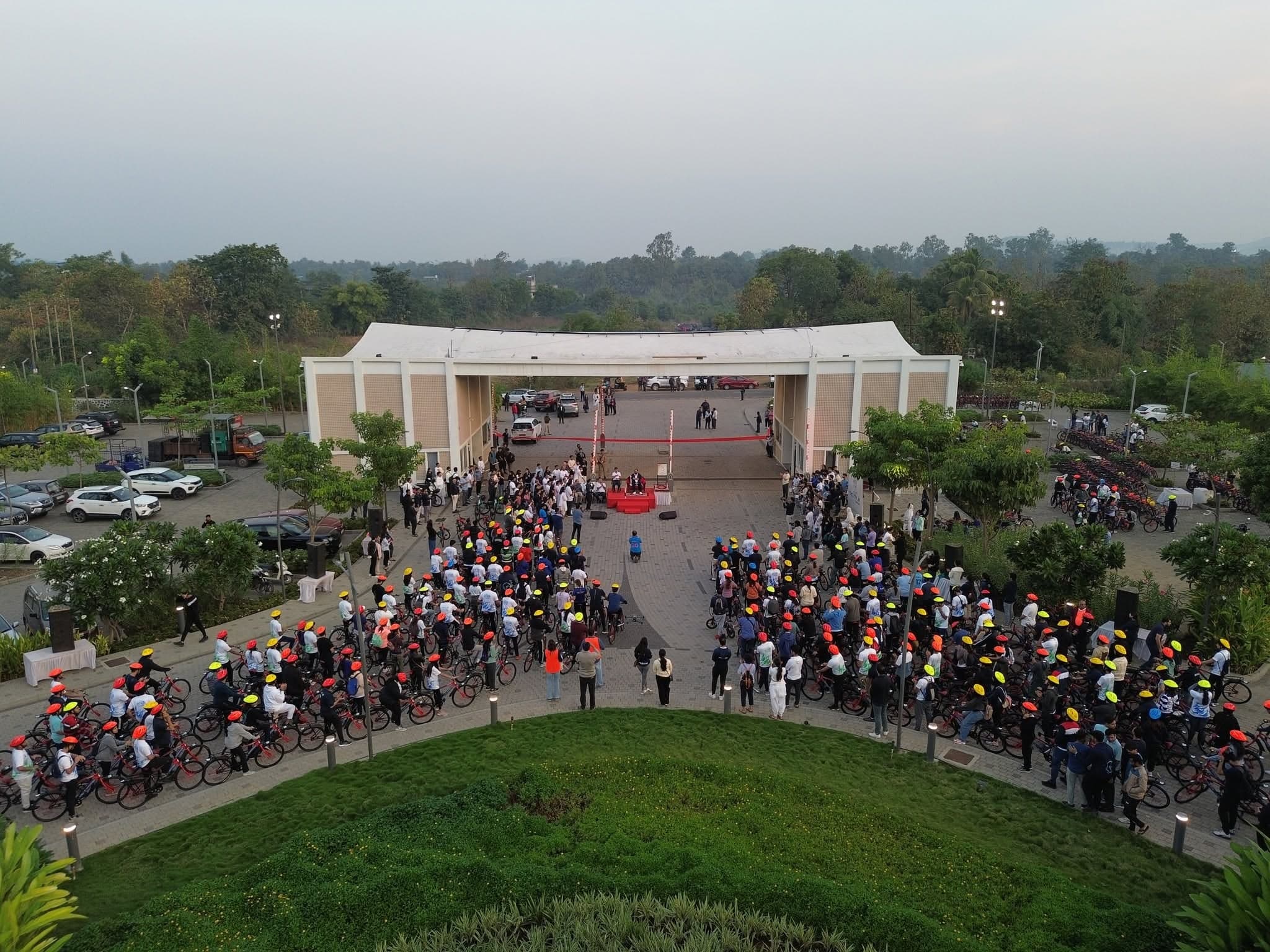 Aerial view of cyclists gathering at the Ashram entrance for the 2023 festival