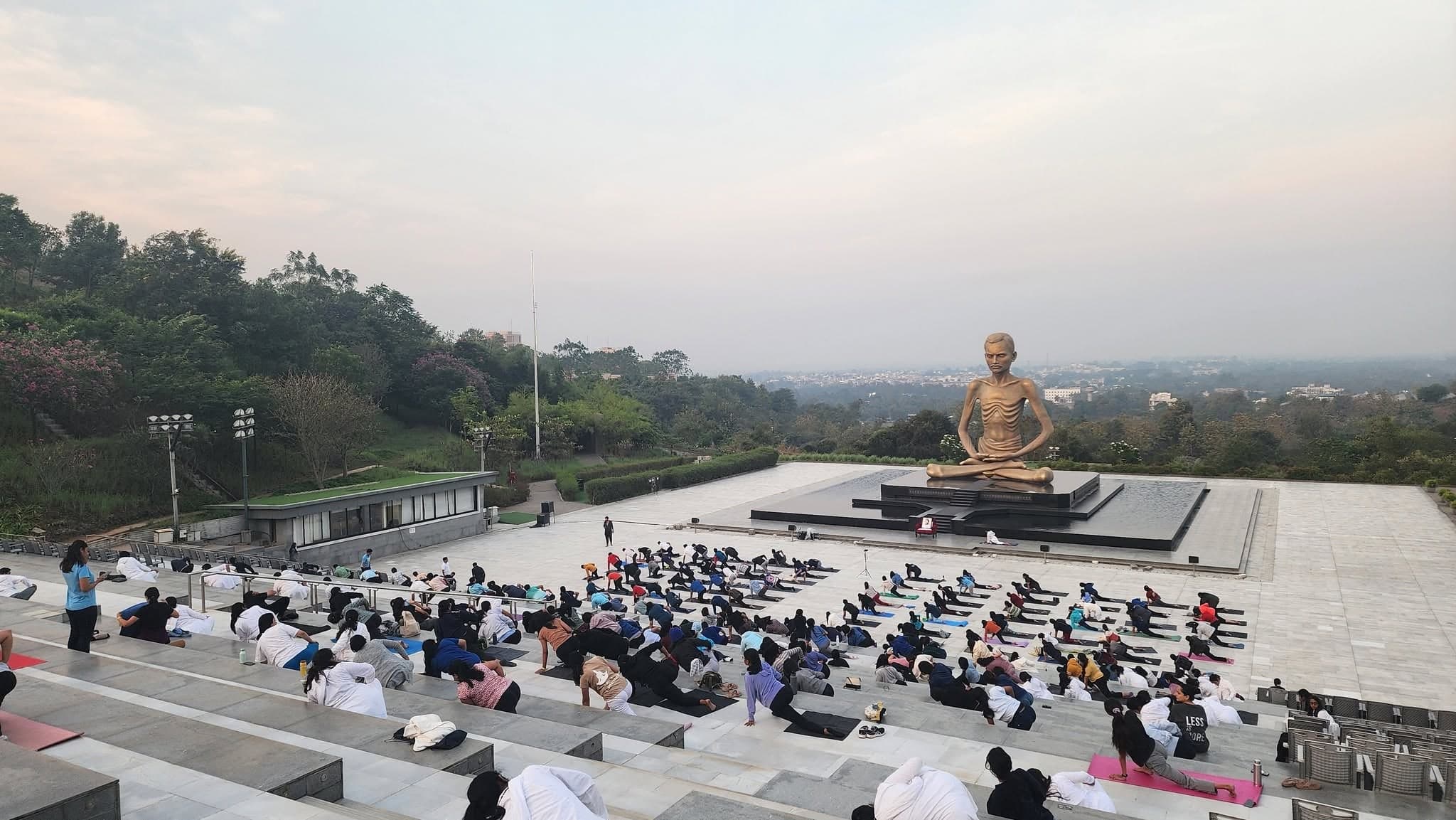Festival participants gather for an outdoor practice session overlooking the Ashram grounds