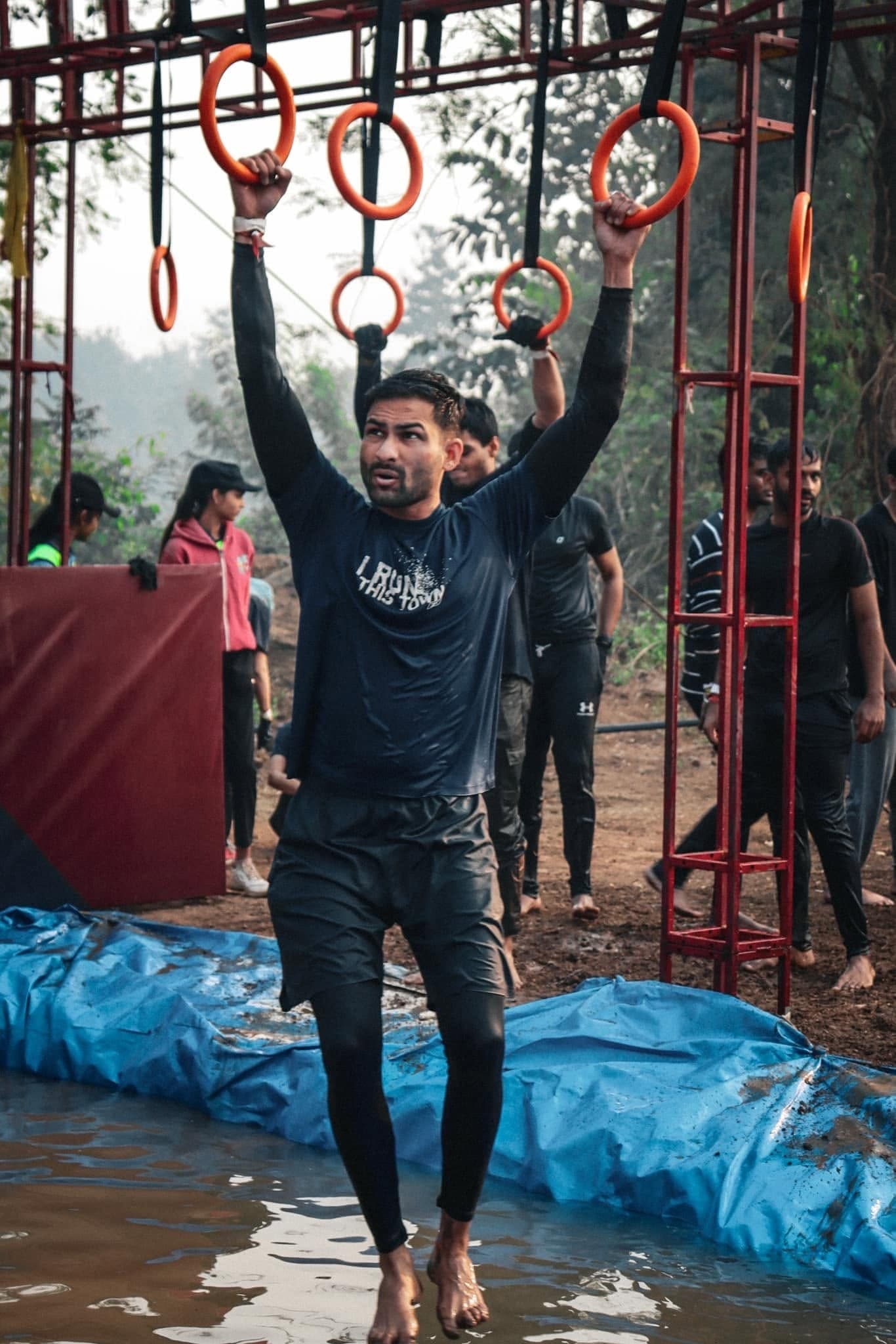 A participant crosses an overhead ring obstacle at the 2024 festival