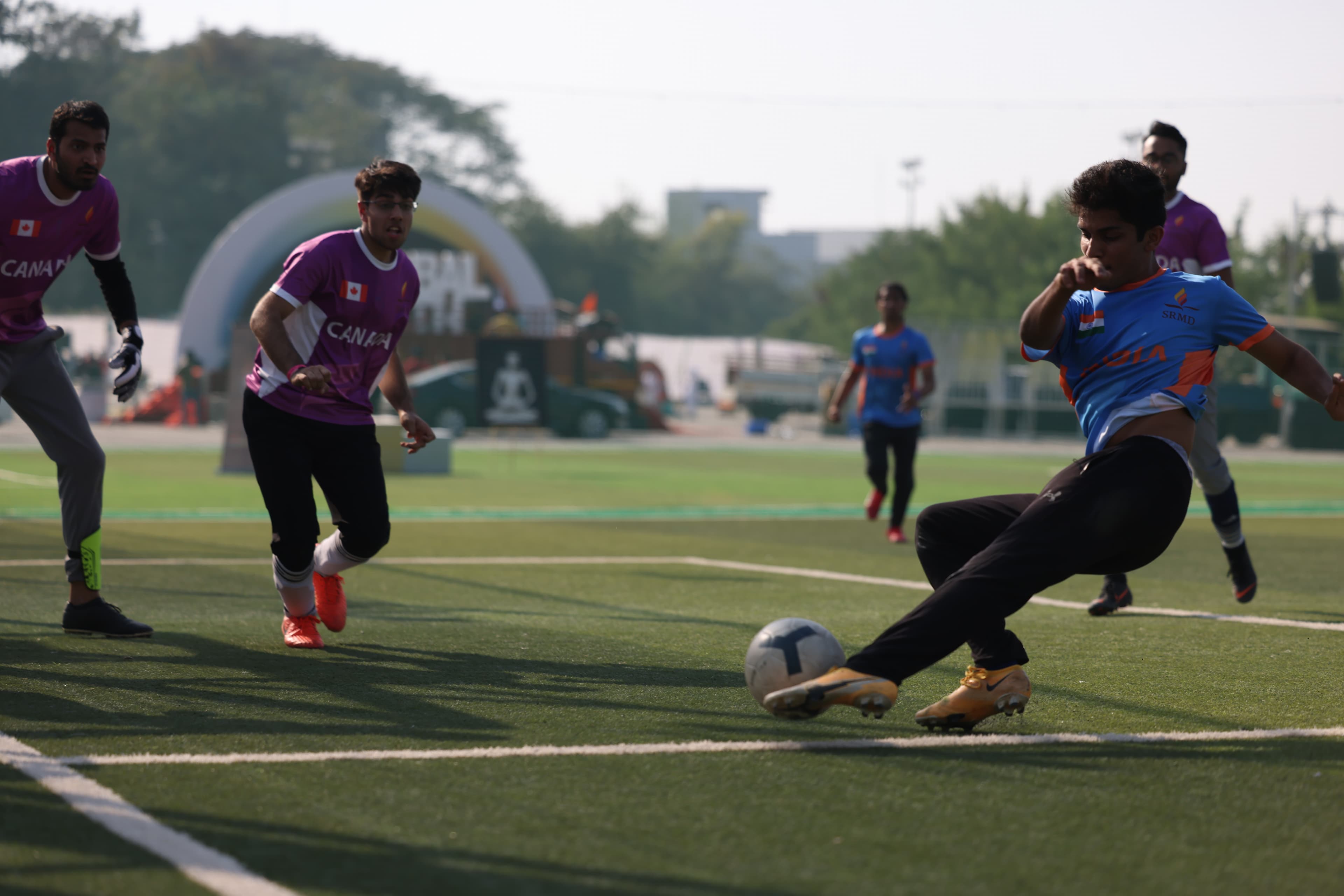 Youth in India and Canada team jerseys competing in football at GYF